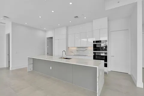 a kitchen with stainless steel appliances a sink and cabinets