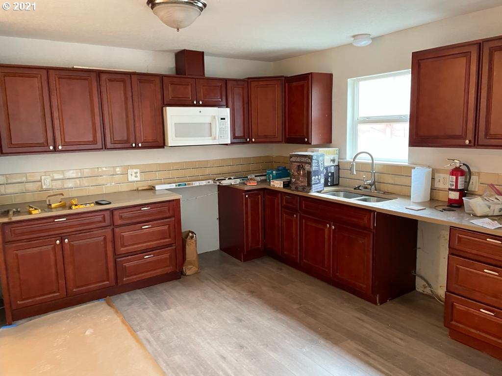 5720 Southeast Jenne Road Portland, OR 97236 - Photo 8 of 23 a kitchen with stainless steel appliances granite countertop wooden cabinets a stove a sink and dishwasher