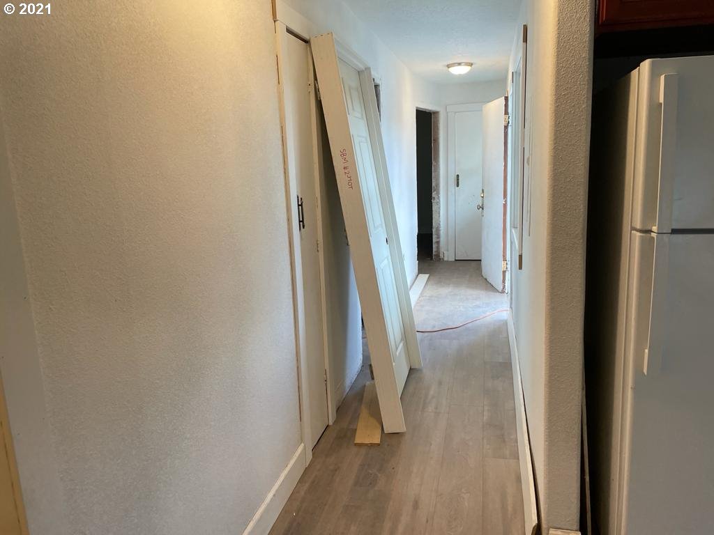 5720 Southeast Jenne Road Portland, OR 97236 - Photo 10 of 23 a view of a hallway with wooden floor