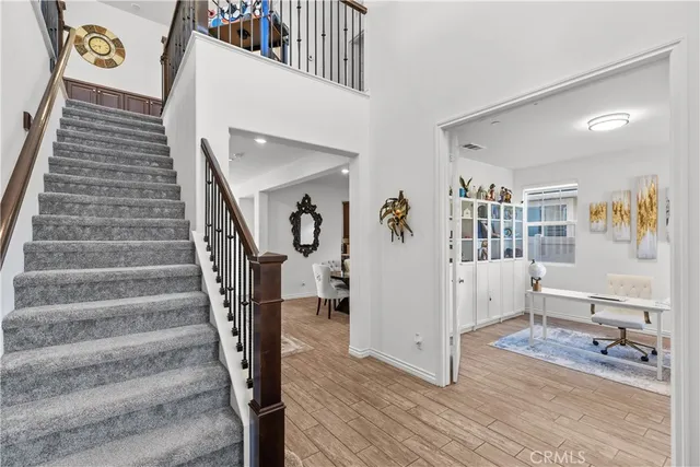 a view of entryway and hall with wooden floor