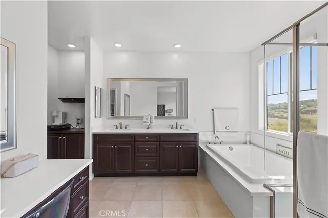 a large kitchen with a large counter top sink and cabinets