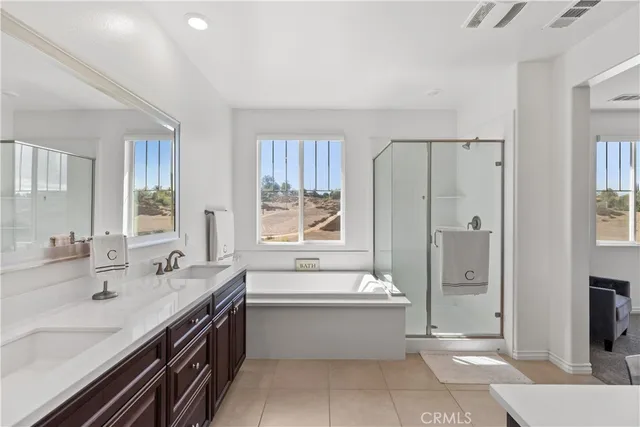 a bathroom with a tub sink shower and mirror