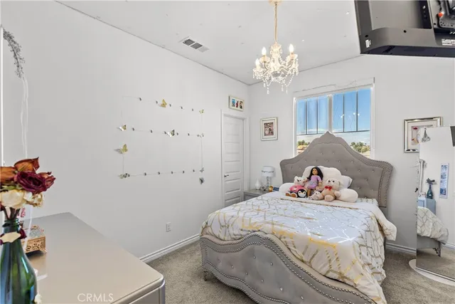 a bedroom with a bed and a chandelier