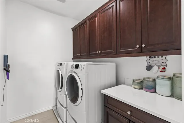 a utility room with sink dryer and washer