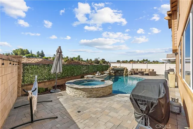 a view of a terrace with furniture and a garden