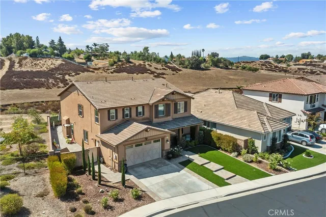 an aerial view of a house with a yard