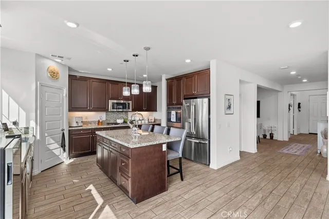 a kitchen with refrigerator a sink and wooden cabinets