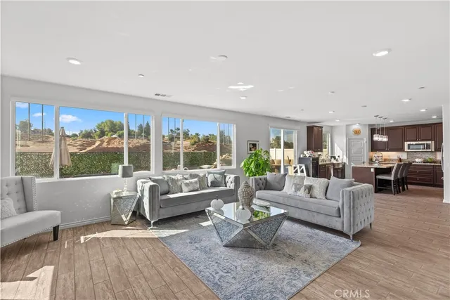 a living room with furniture and large windows