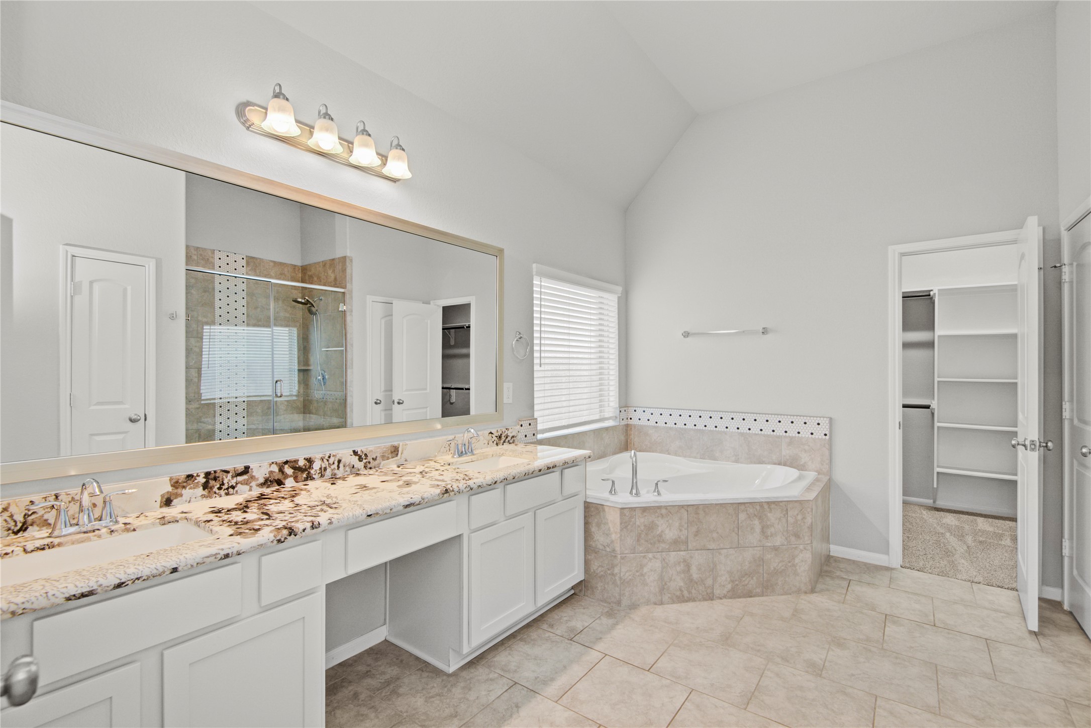 1314 Orchard Ridge Lane Tomball, TX 77375 - Photo 22 of 35 The primary bathroom includes a dual-sink vanity with ample counter space and modern finishes.