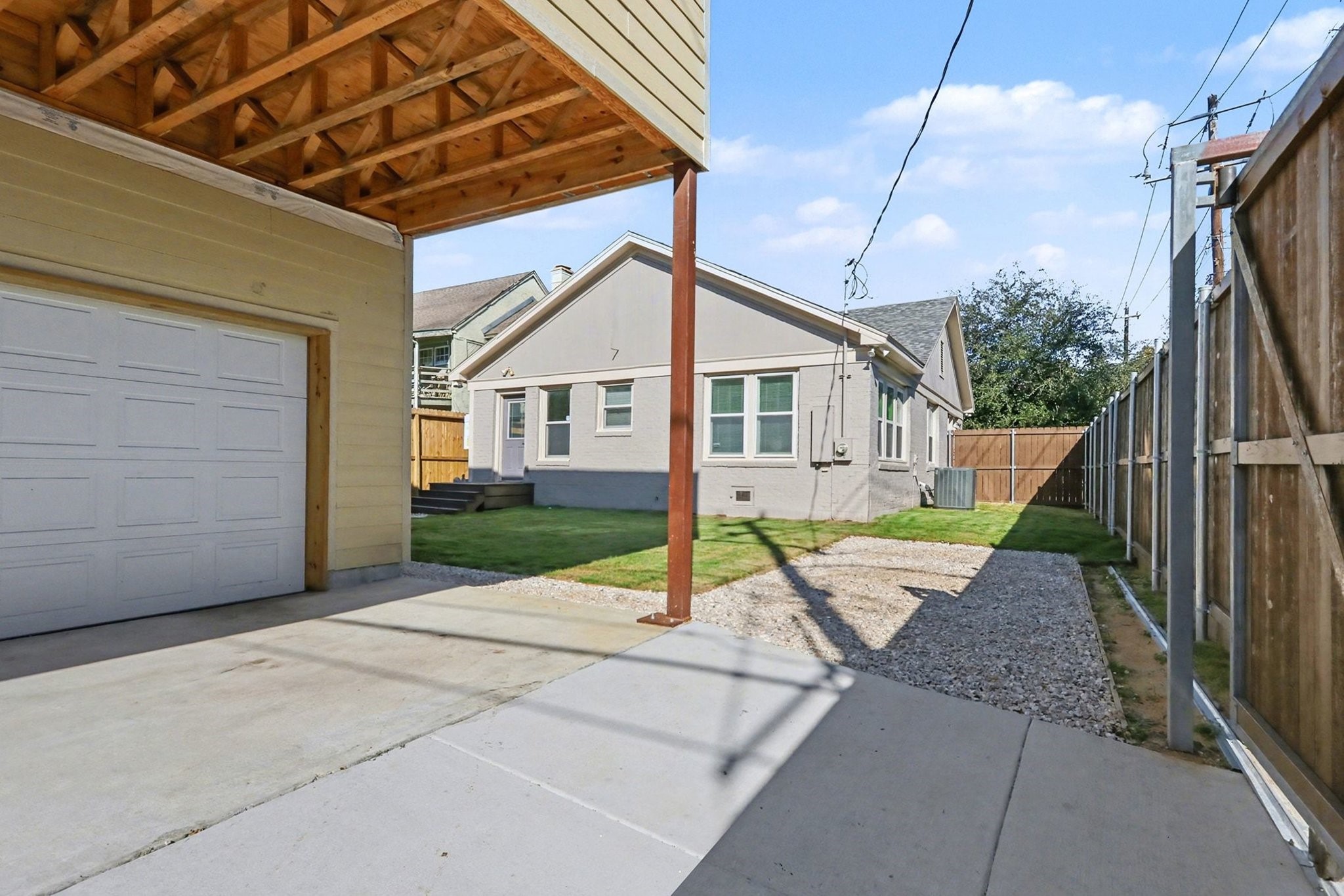 1901 Lexington Street Houston, TX 77098 - Photo 25 of 32 This home features a spacious double-wide driveway leading into the garage with an additional parking space to the right of the driveway. Also seen in distance is the side yard outside of the bedrooms.