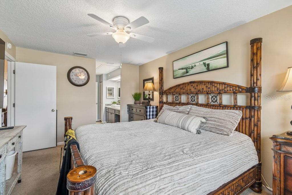 4753 Sunny Loop Holiday, FL 34690 - Photo 19 of 39 a bedroom with a bed and a chandelier