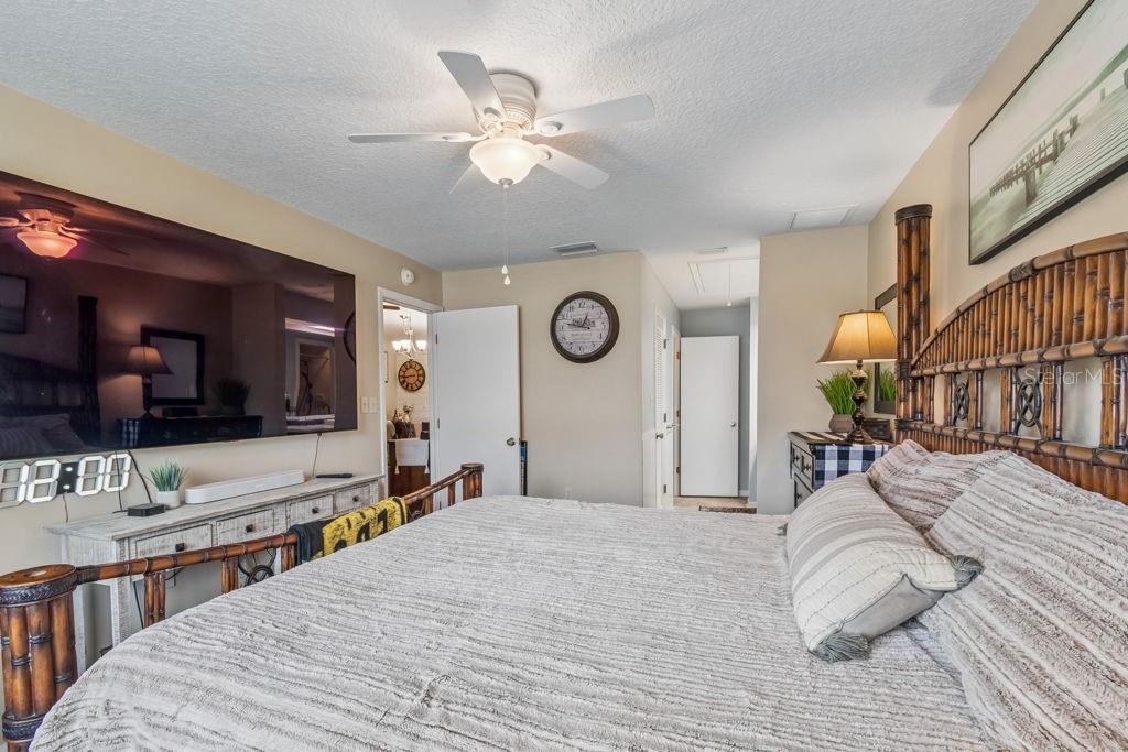 4753 Sunny Loop Holiday, FL 34690 - Photo 20 of 39 a bedroom with a bed and ceiling fan