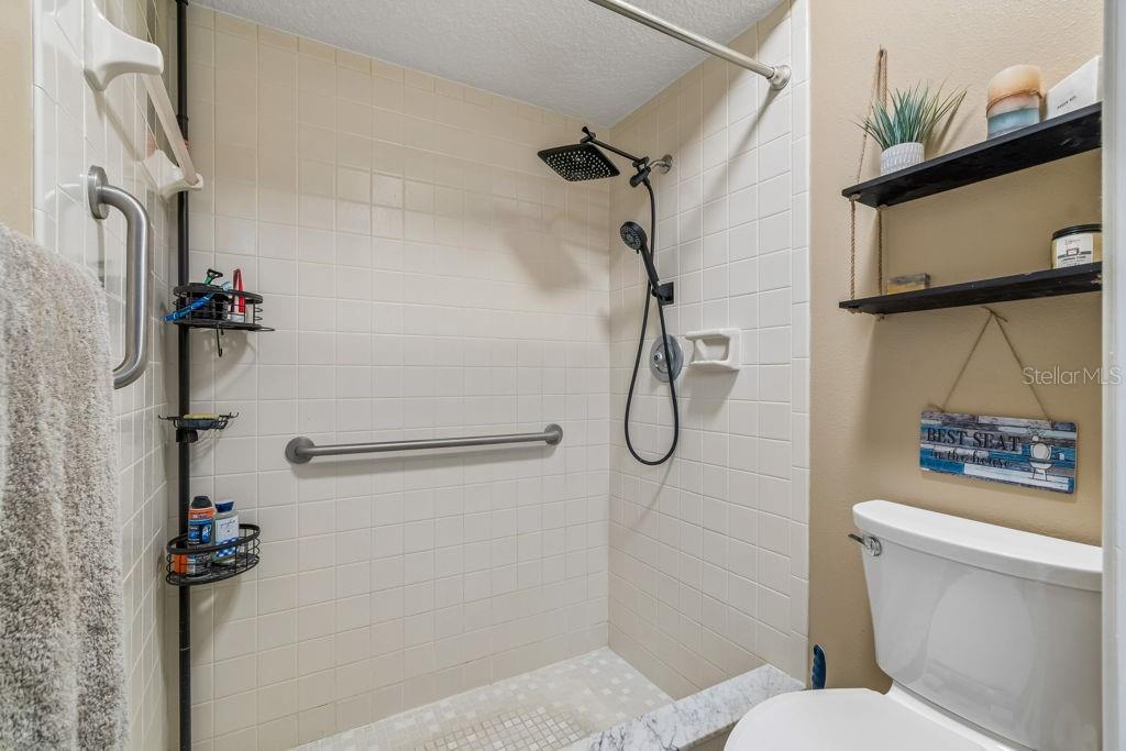 4753 Sunny Loop Holiday, FL 34690 - Photo 22 of 39 a bathroom with a toilet sink and shower