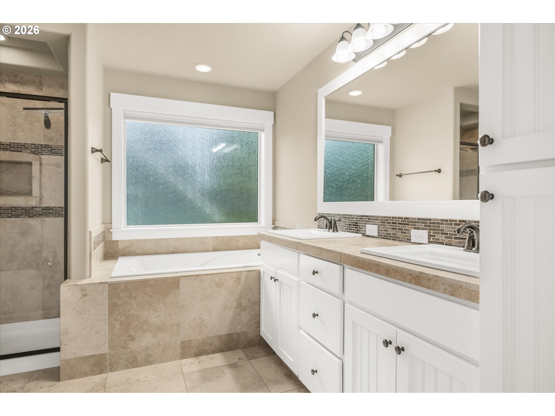 16073 Southeast Pinot Road Milwaukie, OR 97267 - Photo 23 of 44 a bathroom with a sink mirror and a bathtub next to a window