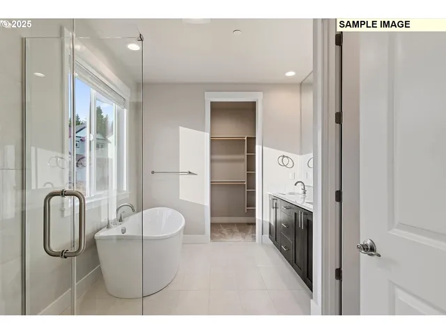 a spacious bathroom with a tub sink shower and mirror