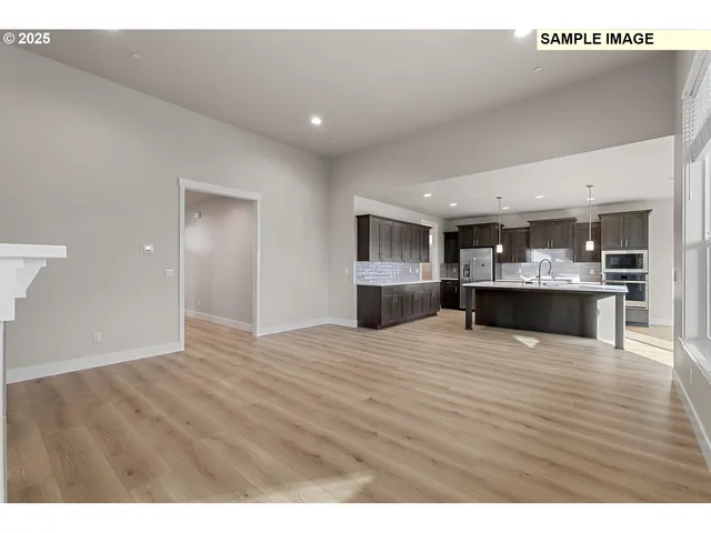 a view of kitchen with kitchen island and stainless steel appliances