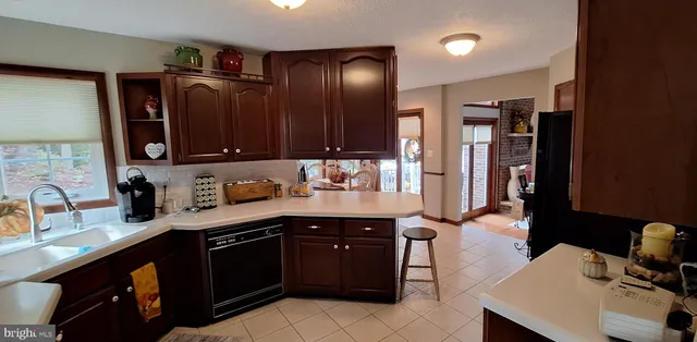 a bedroom with a bed and a flat tv screen on the dresser