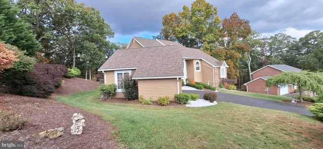 a front view of a house with a yard and a garage