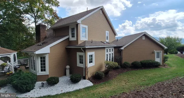 a front view of house with a garden