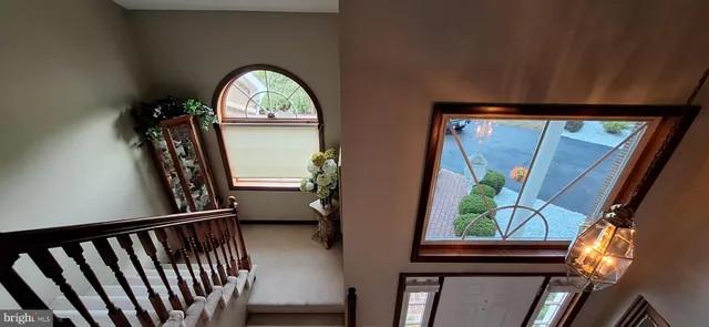 a living room with a bed furniture and a flat screen tv