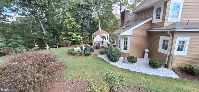 a front view of a house with a yard and potted plants