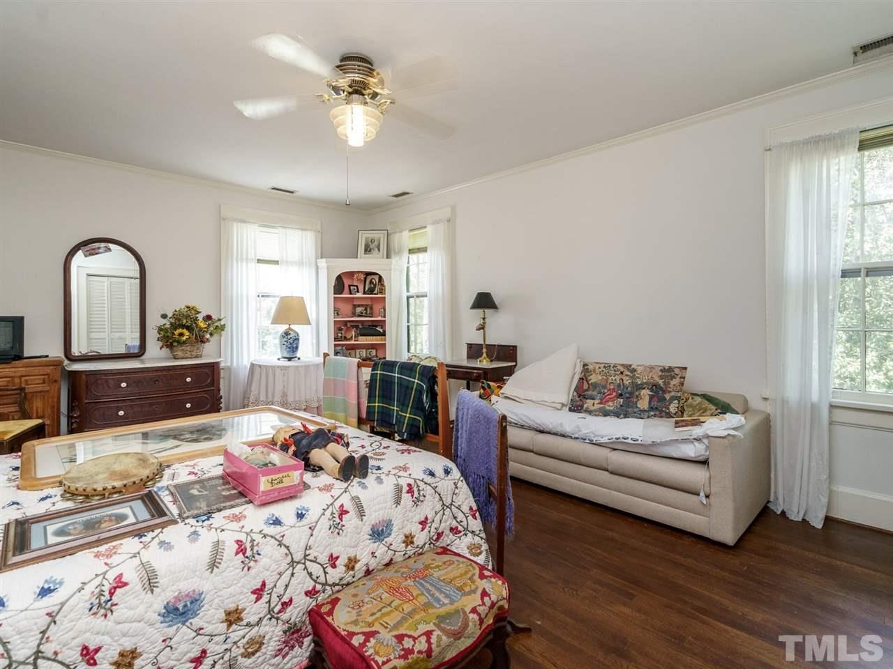 2004 Stone Street Raleigh, NC 27608 - Photo 15 of 23 a bedroom with a bed dresser and wooden floor