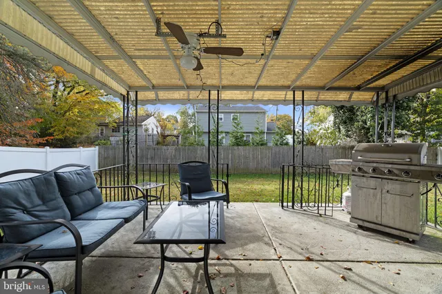 a view of chairs and table in backyard