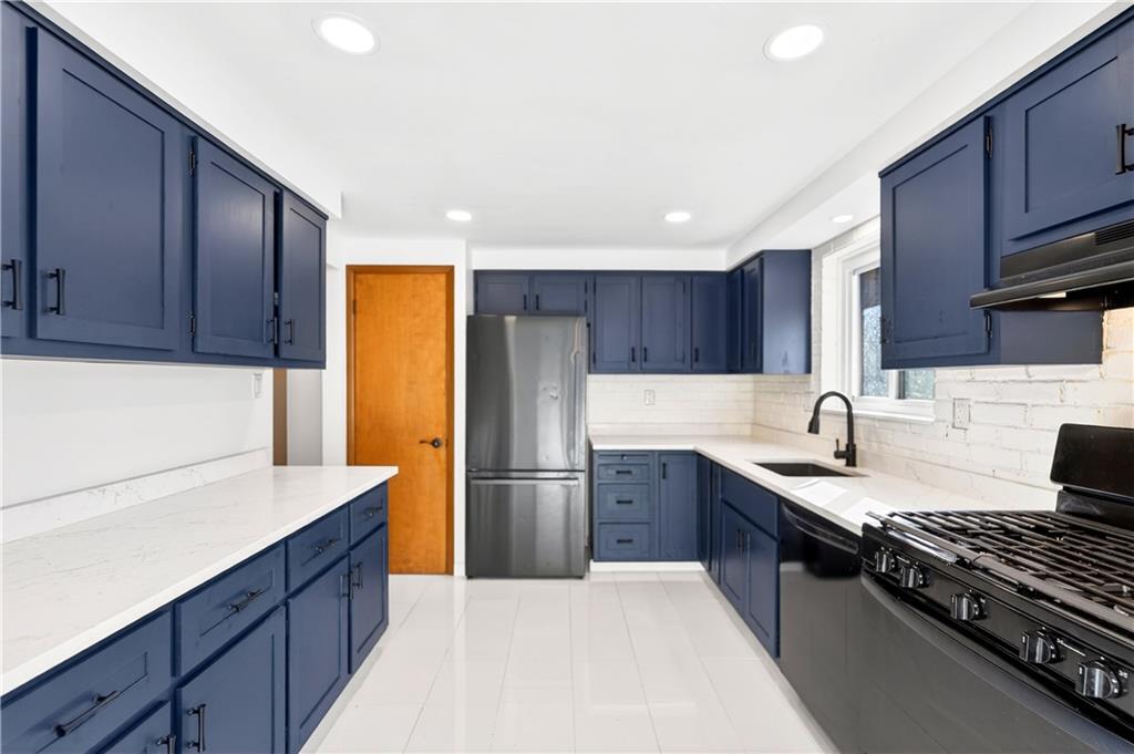 224 Salem Church Road Rostraver Township, PA 15012 - Photo 23 of 48 a kitchen with stainless steel appliances granite countertop a refrigerator stove sink and cabinets