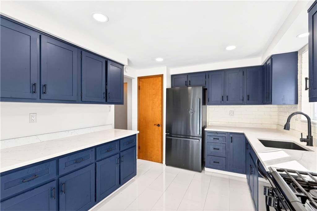 224 Salem Church Road Rostraver Township, PA 15012 - Photo 24 of 48 a kitchen with wooden cabinets and stainless steel appliances