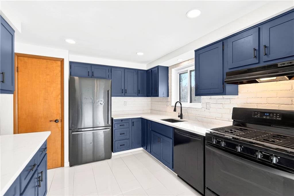 224 Salem Church Road Rostraver Township, PA 15012 - Photo 25 of 48 a kitchen with kitchen island granite countertop a sink stove and refrigerator