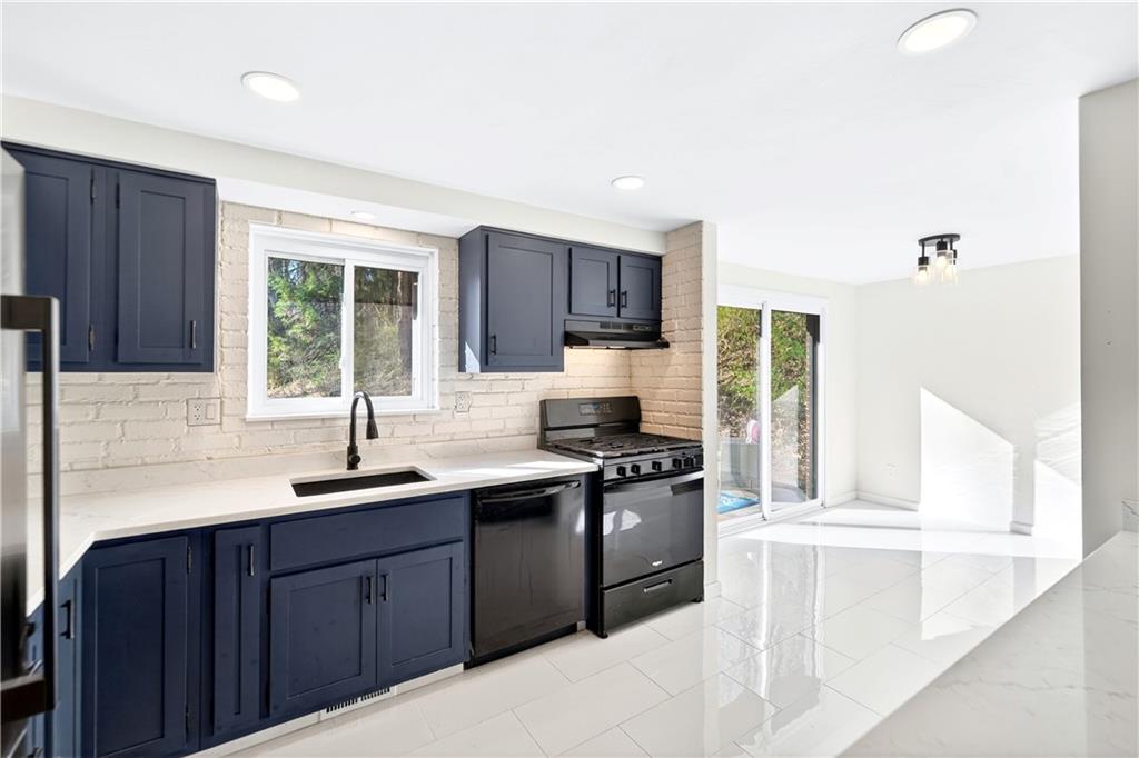 224 Salem Church Road Rostraver Township, PA 15012 - Photo 27 of 48 a kitchen with stainless steel appliances granite countertop a sink stove and cabinets