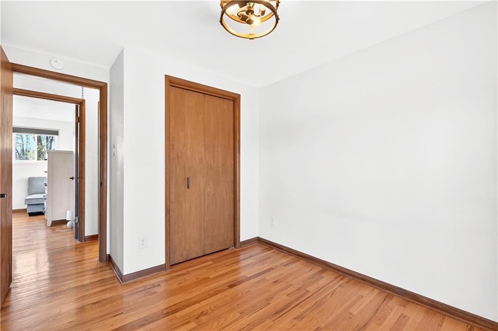 224 Salem Church Road Rostraver Township, PA 15012 - Photo 35 of 48 a view of an empty room with wooden floor and a chandelier