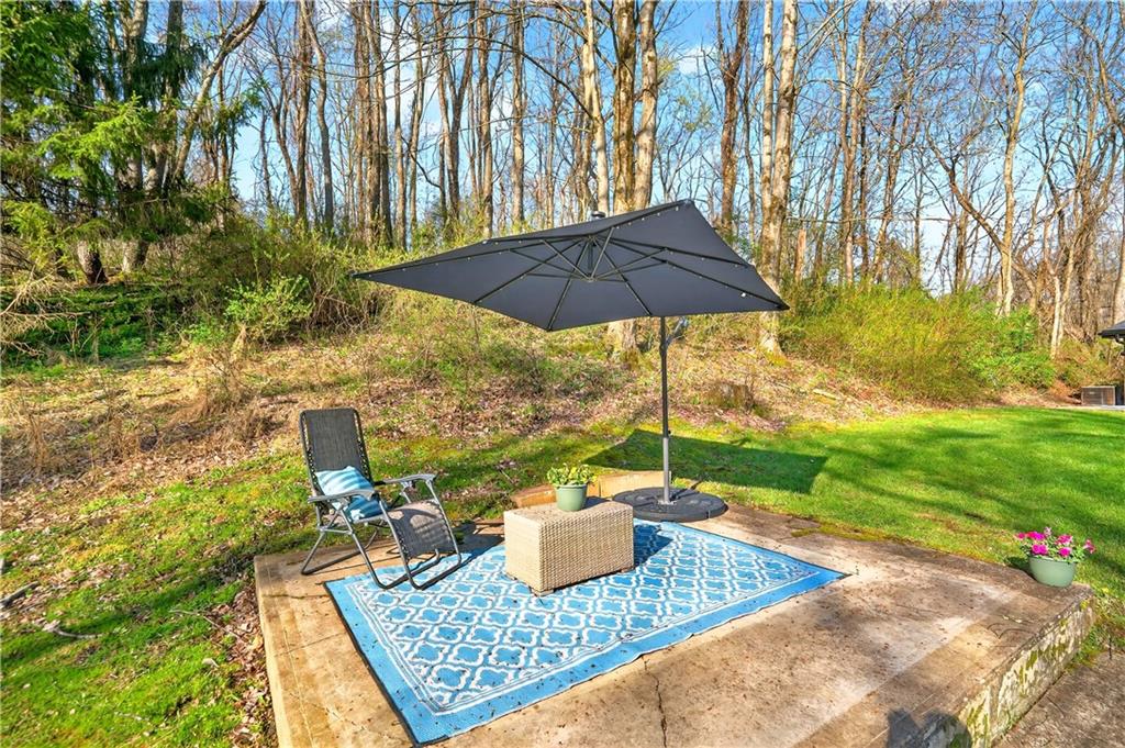 224 Salem Church Road Rostraver Township, PA 15012 - Photo 9 of 48 a view of a roof deck with table and chairs under an umbrella