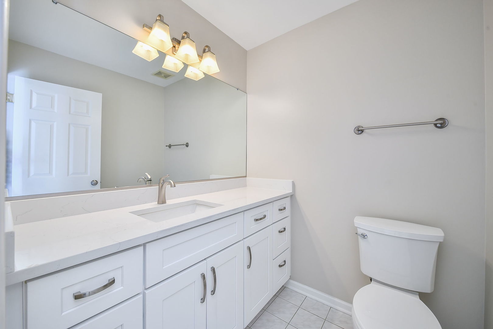 389 Colonial Circle Geneva, IL 60134 - Photo 11 of 25 a bathroom with a toilet sink and mirror