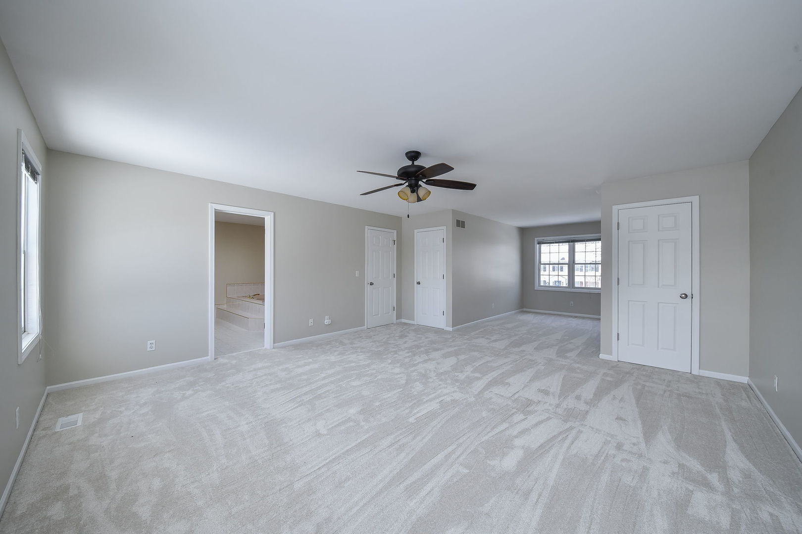 389 Colonial Circle Geneva, IL 60134 - Photo 13 of 25 a view of a big room with windows and ceiling fan