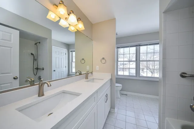 a bathroom with a sink double vanity and a mirror