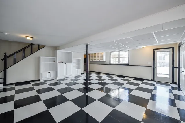 a view of a black and white checkered floor in a room