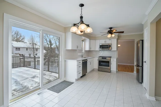 a kitchen with granite countertop a refrigerator and a stove