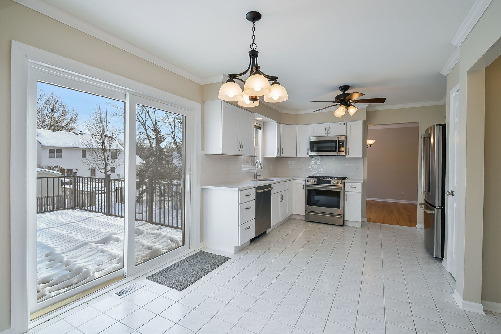 389 Colonial Circle Geneva, IL 60134 - Photo 7 of 25 a kitchen with granite countertop a refrigerator and a stove
