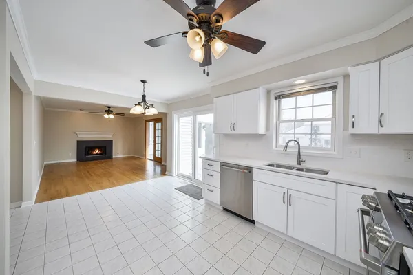 a kitchen with a sink dishwasher a stove and a window