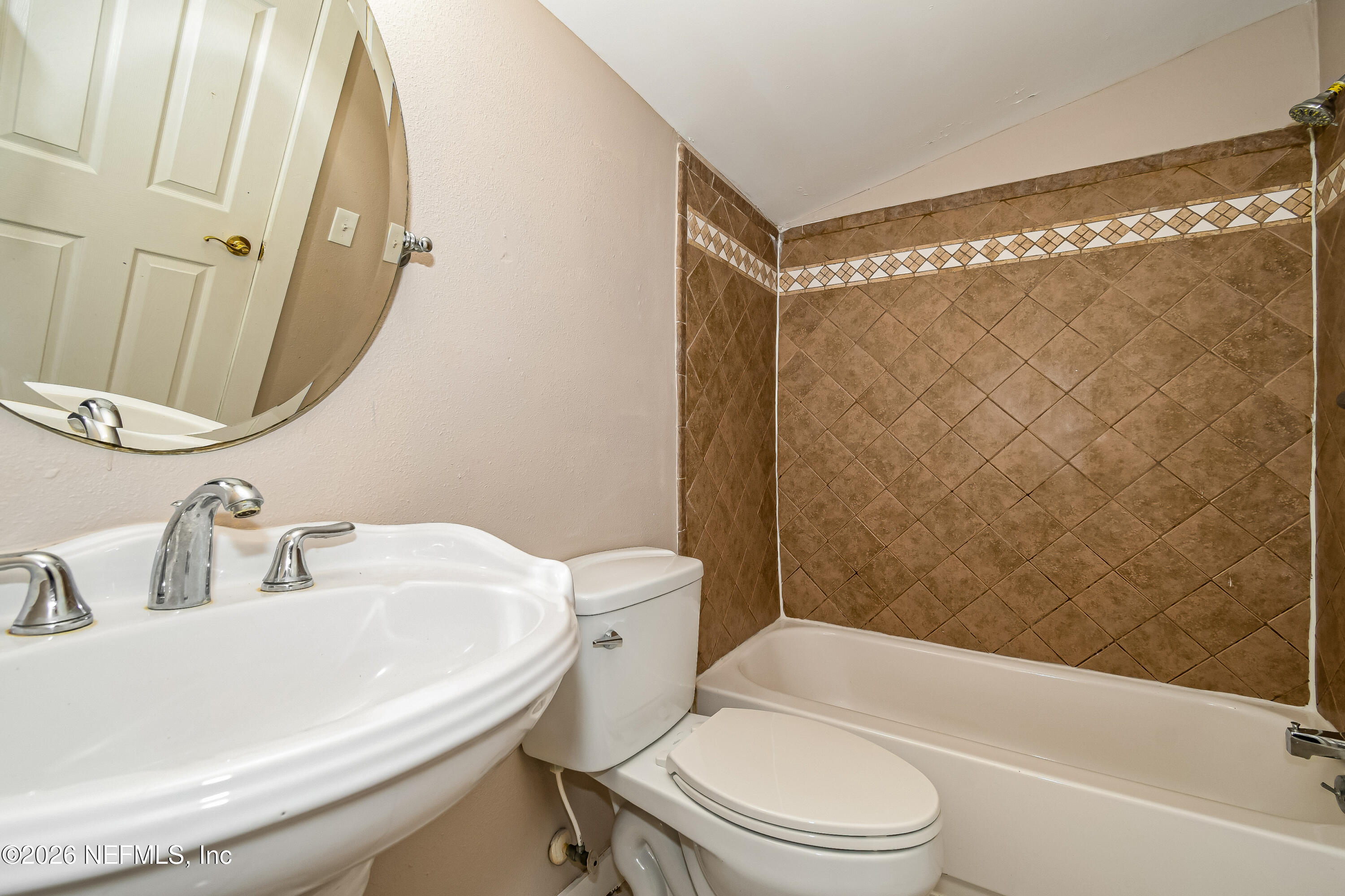 7227 Stonehurst Road North Jacksonville, FL 32277 - Photo 5 of 16 a bathroom with a sink toilet and shower