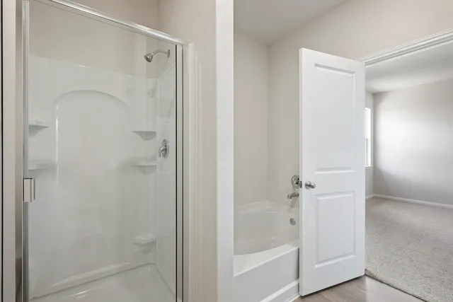 a bathroom with a glass shower door