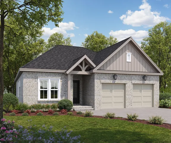 a front view of a house with a yard and plants