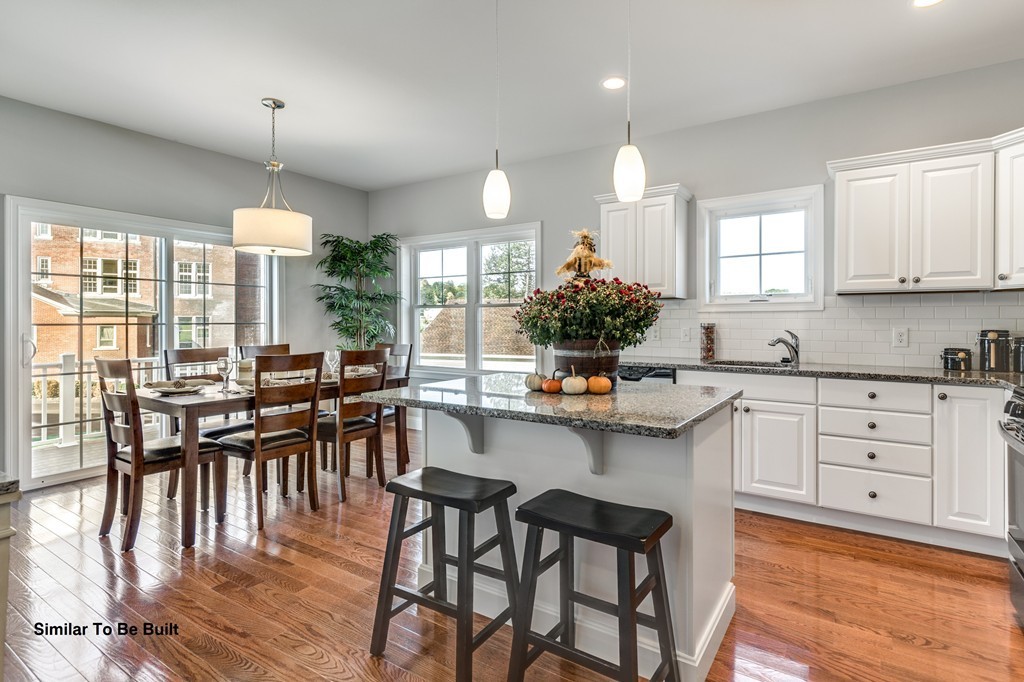 29 Eagle Nest Road, Unit 3 Long Valley, NJ 07853 - Photo 11 of 28 a kitchen with a table chairs stove and cabinets