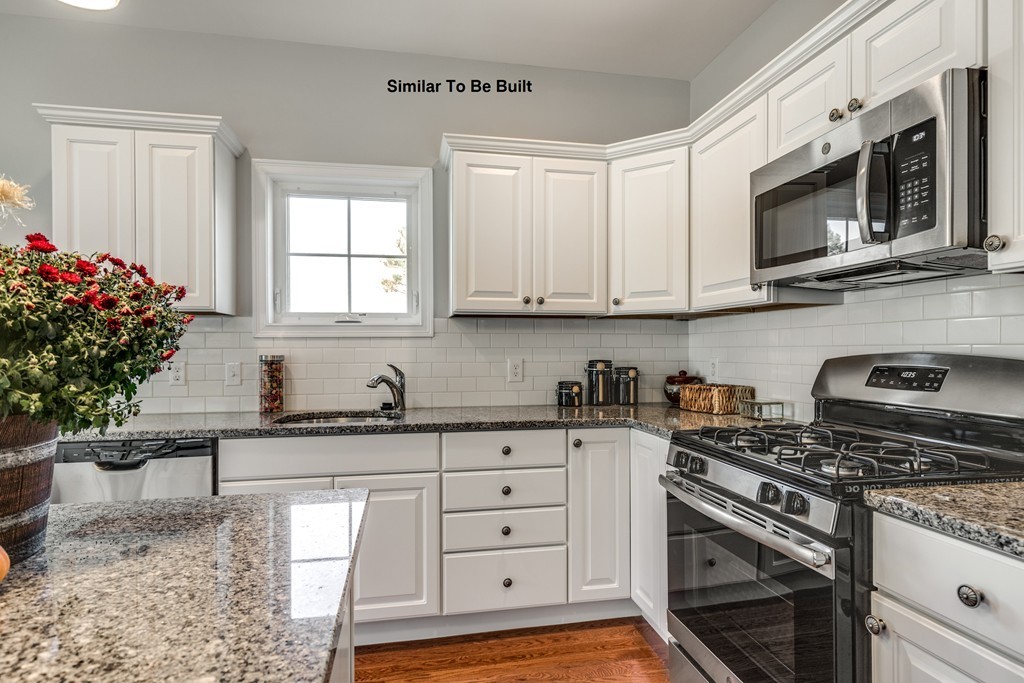 29 Eagle Nest Road, Unit 3 Long Valley, NJ 07853 - Photo 15 of 28 a kitchen with stainless steel appliances granite countertop a sink stove top oven and microwave