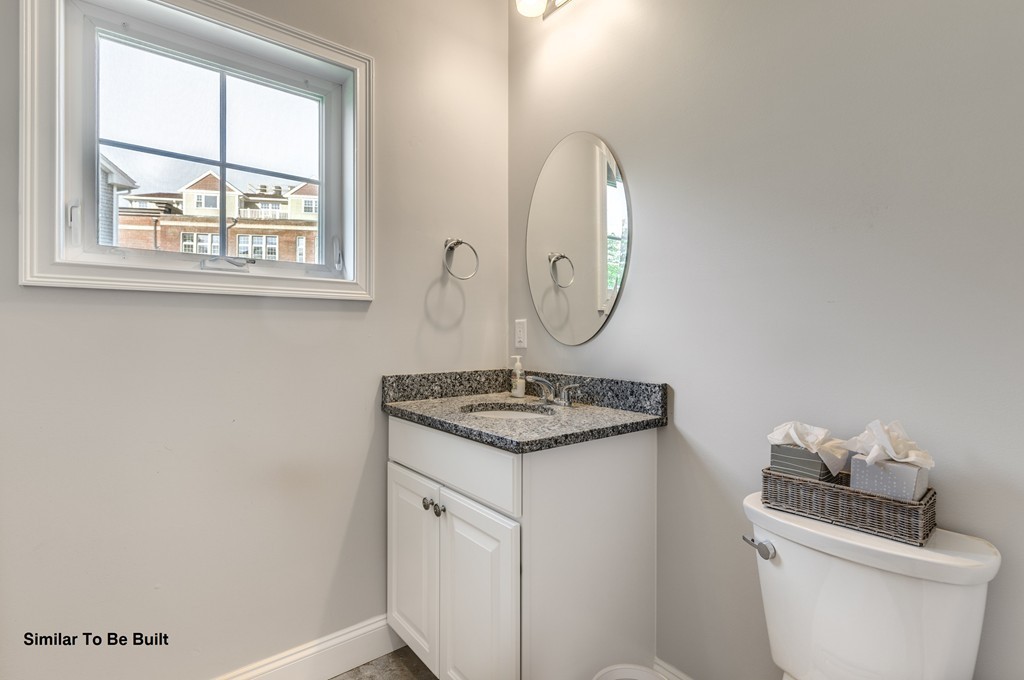 29 Eagle Nest Road, Unit 3 Long Valley, NJ 07853 - Photo 10 of 28 a bathroom with a granite countertop toilet a sink and a mirror
