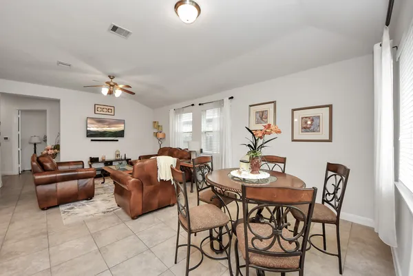 a living room with furniture a chandelier and a window