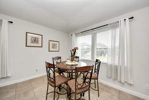 a dining room with furniture and window