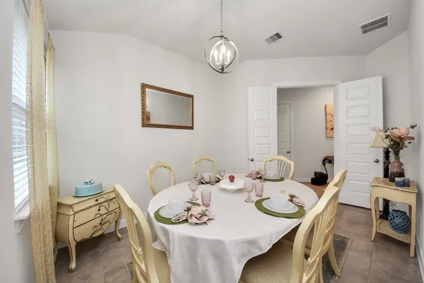 a view of a dining room with furniture and chandelier