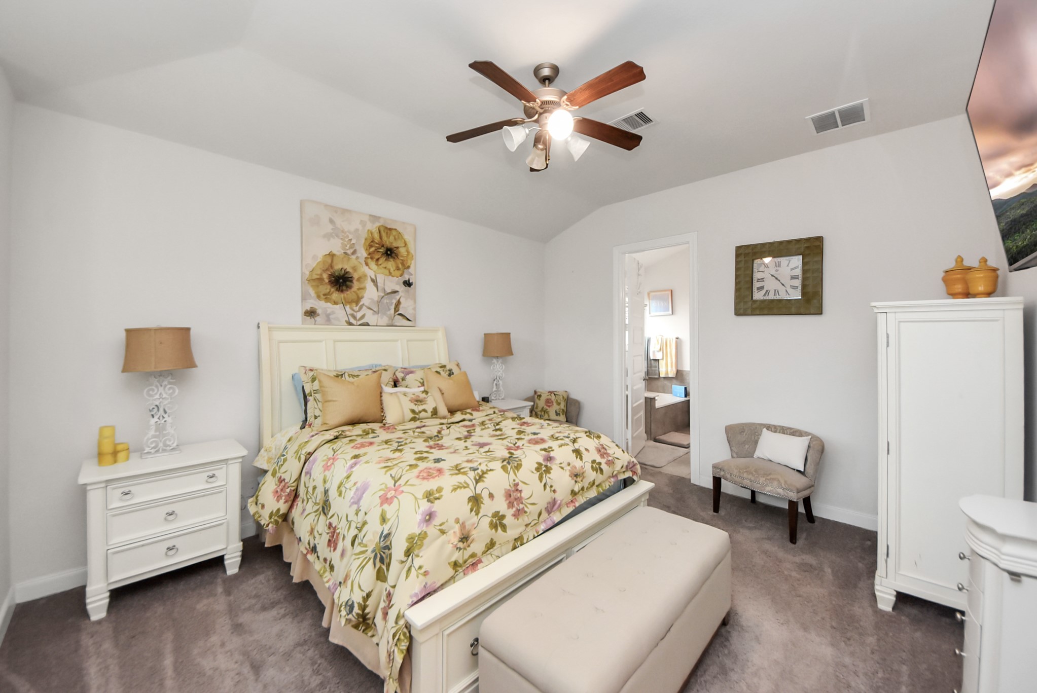 8806 Chapada Highlands Drive Cypress, TX 77433 - Photo 24 of 42 a bedroom with a bed and a chandelier